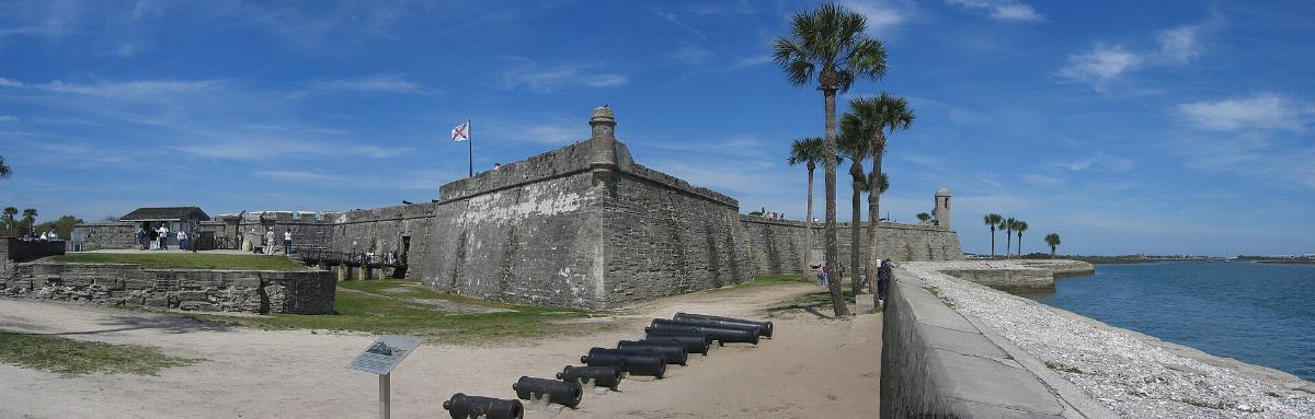 Coquina walls of the Castillo de San Marcos with cannons on the grounds