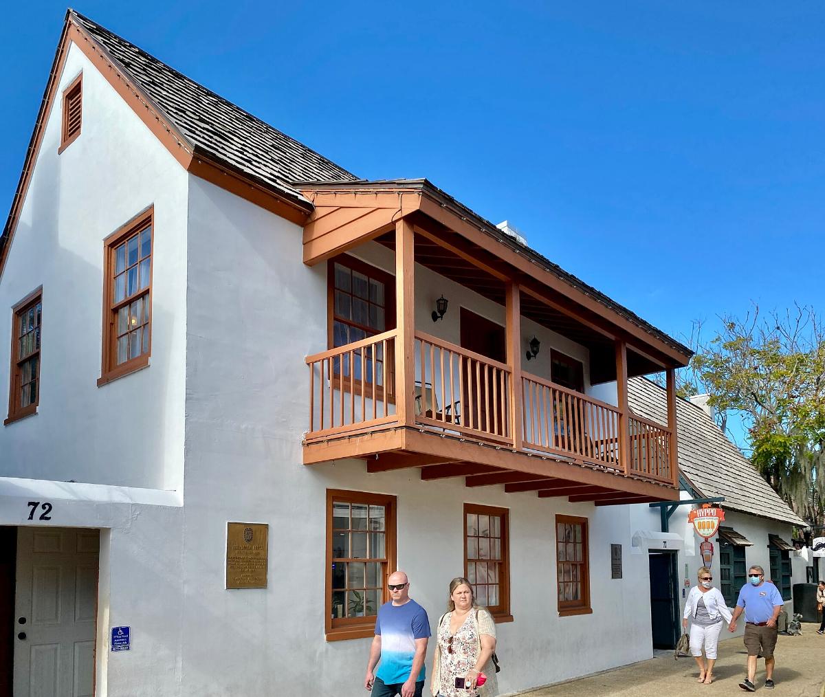 Two-story colonial house with a wooden balcony on St. George Street
